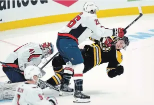  ?? CHARLES KRUPA THE ASSOCIATED PRESS ?? Washington Capitals centre Nic Dowd drops Bruins centre Trent Frederic to the ice Wednesday night. Frederic was later speared by Capitals captain Alex Ovechkin.