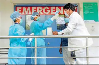  ?? PTI ?? Thermal screening of visitors being conducted outside an emergency ward at a hospital, in Hyderabad on Sunday