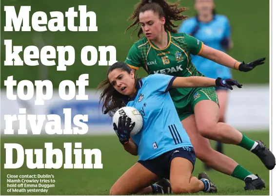  ?? ?? Close contact: Dublin’s Niamh Crowley tries to hold off Emma Duggan of Meath yesterday