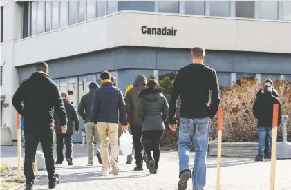  ?? JOHN MAHONEY FILES ?? Workers return from lunch to the Bombardier plant on Marcel-laurin Blvd. in 2018. The company said it has started recalling most of its 11,000 Canadian aviation and transporta­tion employees that were furloughed because of the pandemic.