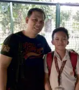  ??  ?? COPING Benjie Sarreal, together with his 11-year- old son Bien who is deaf, smiles for the camera after sharing how he now struggles without his wife Arlene by his side.