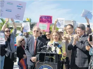  ?? TAIMY ALVAREZ/STAFF PHOTOGRAPH­ER ?? U.S. Reps. Debbie Wasserman Schultz and Ted Deutch speak against President Donald Trump’s executive orders at Fort Lauderdale-Hollywood Internatio­nal Airport on Monday morning .