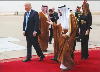  ?? The Associated Press ?? U.S. President Donald Trump, left, and first lady Melania Trump, right, are welcomed by Saudi King Salman, centre, during a welcome ceremony at the Royal Terminal of King Khalid Internatio­nal Airport on Saturday in Riyadh.