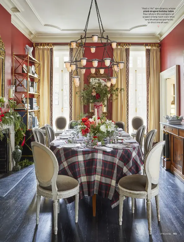  ?? ?? “Red is life!” says Branca, whose plaid-draped holiday table flourishes in the company of glazed dining room walls that “lend themselves perfectly to this time of year.”