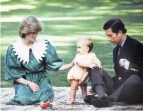  ?? PHOTO: THE NEW ZEALAND HERALD ?? Princess Diana and Prince Charles play with Prince William and a Buzzy Bee toy on the lawn of Auckland’s Government House on this day in 1983.