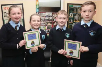  ??  ?? Pupils from Scoil Naomh Treasa in Bellewstow­n launching a book of recepies contribute­d by local families.