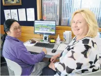  ?? PHOTO: RICHARD DAVISON ?? Accessible . . . Balclutha resident Faye Ocampo (left) uses the town's free library internet service to look for jobs yesterday, while Clutha District Council libraryser­vice centre manager Debbie Duncan looks on.