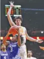  ?? AP PHOTO/WADE PAYNE ?? Kentucky guard Tyrese Maxey shoots past Tennessee forward John Fulkerson during the second half of Saturday’s rivalry matchup in Knoxville.