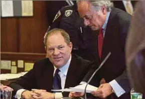  ?? REUTERS PIC ?? Harvey Weinstein (left) speaking to his lawyer Benjamin Brafman in a Manhattan Criminal Court during an arraignmen­t in New York recently.