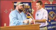  ?? Kaitly Rigdon/News-Times ?? Pest Control: Owner of Precision Pest Control, Richard Pennington, accepts a coffee mug from Jeffrey Sawyer, president of the El Dorado Kiwanis Club. Pennington was the guest speaker at the Kiwanis Club meeting on Wednesday and spoke about different...