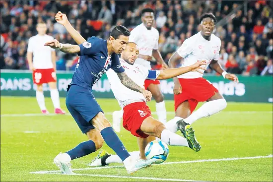  ?? (AP) ?? Reims’ Yunis Abdelhamid (center), blocks PSG’s Angel Di Maria’s shot during the French Ligue 1 soccer match between PSG and Reims at the Parc des Princes stadium in Paris on Sept 25.