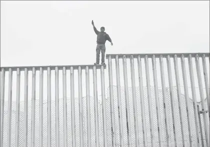  ?? Foto Xinhua ?? En Playas de Tijuana, un joven posa en lo más alto de la valla fronteriza con Estados Unidos