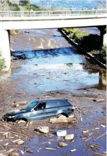  ??  ?? CALIFORNIA MUDSLIDES – A car is stuck in mud on the 101 Freeway in Montecito, California, after heavy rains caused deadly mudslides. (EPA-EFE)