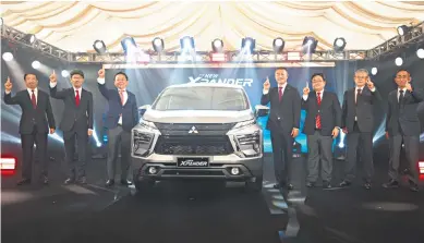  ?? ?? Flanking the new Xpander are (from left) Mitsubishi Motors Philippine­s Corp. (MMPC) EVP for Corporate Takehisa Usami, MMPC EVP for Sales and Marketing Takanobu Suzuki, Mitsubishi Motors Corp. EVP for Sales Yoichiro Yatabe, MMPC President and CEO Takeshi Hara, MMPC CFO and EVP for Finance Michihiro Toyomizu, MMPC EVP for Manufactur­ing Yoshiaki Onomura (outgoing), and MMPC EVP for Manufactur­ing Taro Soga.