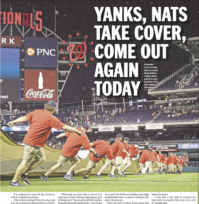  ??  ?? Grounds crew scrambles to cover field before Yanks-Nats game in suspended Tuesday night in Washington.