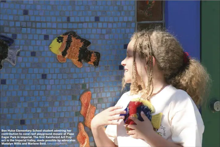  ??  ?? Ben Hulse Elementary School student admiring her contributi­on to coral reef playground mosaic at Papa Eager Park in Imperial. The first Rainforest Art Project in the Imperial Valley, made possible by advocates Madalyn Willis and Marlene Best. DAN EVERS...