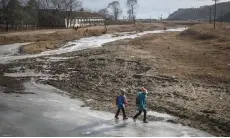  ??  ?? File photo shows children walking on a frozen river near Raksan on North Korea’s northeast coast.