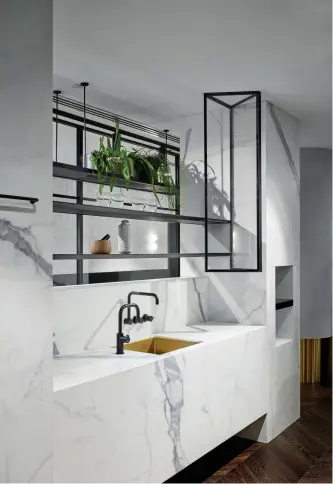  ??  ?? PREVIOUS: Dekton by Cosentino ‘Radium’ – each is still dark and mysterious but has veins, shades and flecks to add depth to the mysterious palette of beguiling black. ABOVE: The sink is a statement piece, and a matte one at that.