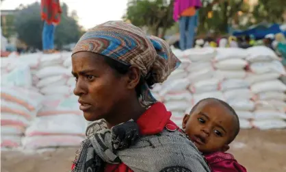  ?? ?? A mother and child queue for food in the Tigray region, Ethiopia. Photograph: Baz Ratner/Reuters