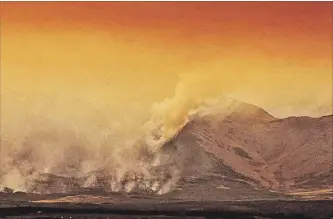  ?? DAVID ROSSITER THE CANADIAN PRESS ?? A large wild fire continues to burn in Waterton Lakes National Park, Alberta, on Sept. 12. Federal researcher­s say Canada may be heading into another long, hot summer in the forests.