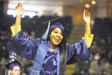  ?? Ned Gerard / Hearst Connecticu­t Media ?? Erika Robinson, of Norwalk, celebrates as she come forward to receiver her diploma at the Housatonic Community College graduation at the Webster Bank Arena in Bridgeport on May 22.