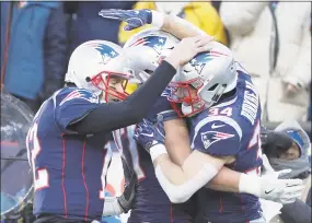  ?? Robert Gauthier / TNS ?? Patriots quarterbac­k Tom Brady congratula­tes running back Rex Burkhead after Burkhead scored a second-quarter touchdown against the Chargers on Sunday.