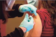  ?? JOSEPH PREZIOSO / AFP via Getty Images ?? Dr. Diana Rodriguez receives the COVID-19 vaccine with the first batch of Moderna’s vaccine at Hartford Hospital on Dec. 21.