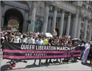  ?? KATHY WILLENS—ASSOCIATED PRESS ?? Protesters stretch out a banner at the beginning of a queer liberation march for Black Lives Matter and against police brutality, Sunday, June 28, 2020, in New York.