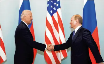 ?? ALEXANDER ZEMLIANICH­ENKO/AP ?? Then-Vice President Joe Biden shakes hands with Russian President Vladimir Putin in Moscow in 2011. Now president and coming off the G7 summit in England, Biden is scheduled to meet Putin one-on-one later this week in Geneva.