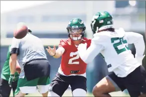  ?? Mike Stobe / Getty Images ?? Jets QB Zach Wilson runs a drill on Tuesday in Florham Park, N.J.