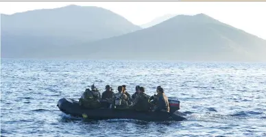  ??  ?? MAKING PRESENCE FELT — Philippine Marines are transporte­d on a rubber boat from a patrol ship after a mission at the disputed Second Thomas Shoal, which is part of the Spratly Islands in the South China Sea, and on their way back to the naval forces...