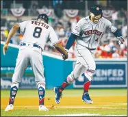  ?? AP/PATRICK SEMANSKY ?? Houston Astros outfielder George Springer (right) celebrates his solo home run in the tenth inning Tuesday during the Major League Baseball All-star Game in Washington.