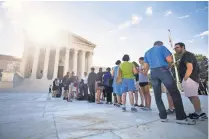  ?? JIM LO SCALZO, EPA ?? People gather Monday outside the Supreme Court, where the justices ruled on President Trump’s travel restrictio­ns.