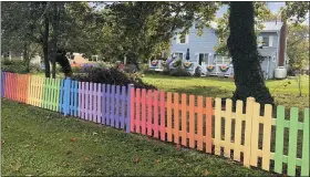  ?? AP PHOTO/CAL WOODWARD ?? A home along Pennsylvan­ia Avenue, in Lovettsvil­le, Va., displays a fence painted in the colors of the gay-pride rainbow flag, on Oct. 4.