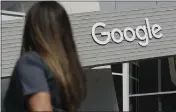  ?? JEFF CHIU — THE ASSOCIATED PRESS FILE ?? A woman walks below a Google sign on the company campus in Mountain View.