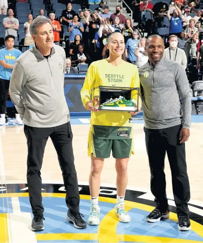  ?? GETTY IMAGES ?? Sky owner Michael Alter and GM/coach James Wade present Storm star Sue Bird with custom-made shoes before the game.