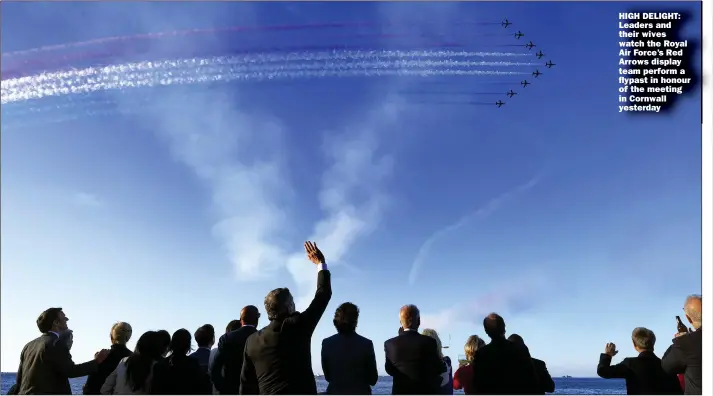  ?? Pictures: STEFAN ROUSSEAU/PA; ANDREW PARSONS & SIMON DAWSON/NO 10 Downing Street ?? HIGH DELIGHT: Leaders and their wives watch the Royal Air Force’s Red Arrows display team perform a flypast in honour of the meeting in Cornwall yesterday