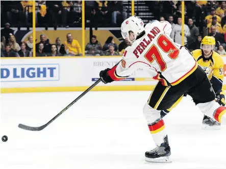  ?? MARK HUMPHREY/THE ASSOCIATED PRESS ?? Flames left winger Micheal Ferland scores one of two goals he counted against the Predators during Tuesday’s game in Nashville. The effort marked Ferland’s first multi-goal game in the NHL and sparked the Flames to a 6-5 overtime victory.