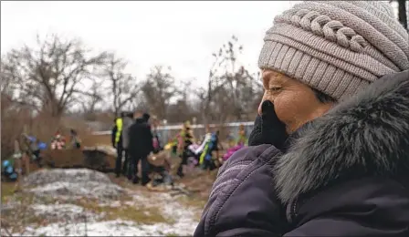  ?? EVGENIY MALOLETKA AP ?? Tamila Pyhyda cries during Monday’s exhumation of her husband, Serhii Pyhyda, killed by Russian forces in Vysokopill­ya, Ukraine.