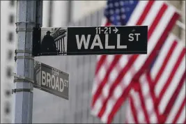  ?? SETH WENIG — THE ASSOCIATED PRESS FILE ?? A street sign is seen in front of the New York Stock Exchange in New York.