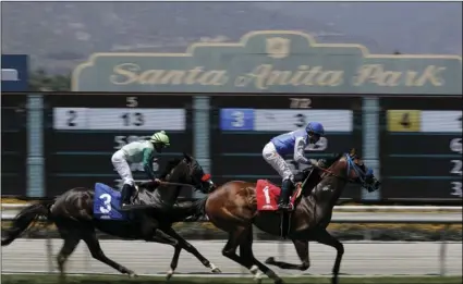  ??  ?? In this June 23 file photo, Eddie Haskell (right), with jockey Kent Desormeaux aboard, wins the third race during the last day of the winter/spring meet at the Santa Anita Park race track in Arcadia, Calif. AP PHOTO/CHRIS CARLSON