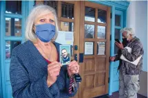  ?? EDDIE MOORE/JOURNAL ?? Susie Schmitt, left, holding a photo of her son, Rex Corcoran Jr., and Antonio DeVargas, right, try to deliver petitions to the Santa Fe County Manager’s office last month. Corcoran and DeVargas’ daughter, Carmela DeVargas, both got sick at the Santa Fe County jail and later died.