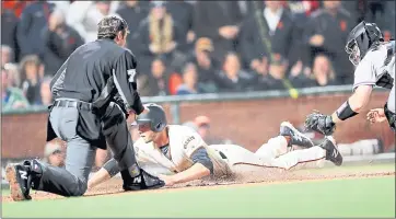  ?? RAY CHAVEZ — STAFF PHOTOGRAPH­ER ?? The Giants’ Austin Slater slides in past Rockies catcher Tom Murphy to score on a sacrifice fly in the seventh inning.