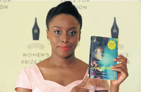  ?? /Reuters ?? Africanah: US-based Nigerian author Chimamanda Ngozi Adichie poses with her novel Americanah ahead of the awarding of the Bailey’s Women’s Prize for Fiction in London on June 4 2014.