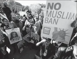  ?? ASSOCIATED PRESS ?? IN THIS OCT. 18 FILE PHOTO, PROTESTERS gather at a rally in Washington. The Supreme Court is allowing the Trump administra­tion to fully enforce a ban on travel to the United States by residents of six mostly Muslim countries.