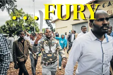  ?? Picture: AFP ?? BLADE MARCHER: A Somali man armed with a machete accompanie­s compatriot­s on a protest march in Pretoria