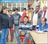  ?? HT PHOTO ?? Young women wrestlers registerin­g themselves for the event.