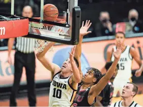  ?? CHARLIE NEIBERGALL/AP ?? Iowa guard Joe Wieskamp (10) drives to the basket in front of Northern Illinois guard Anthony Crump during the first half on Sunday.