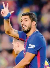  ??  ?? Barcelona’s forward Luis Suarez celebrates a goal against Levante UD at the Camp Nou stadium in Barcelona on Sunday. Barcelona won 3-0.