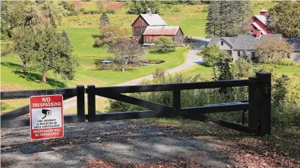  ?? Lisa Rathke/Associated Press ?? A no-trespassin­g sign hangs on a gate outside a private property in Pomfret, Vt.